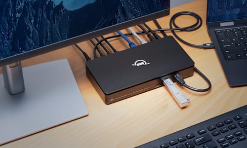 OWC Thunderbolt 5 Dual 10GbE Network Dock on desk with OWC Envoy Pro mini