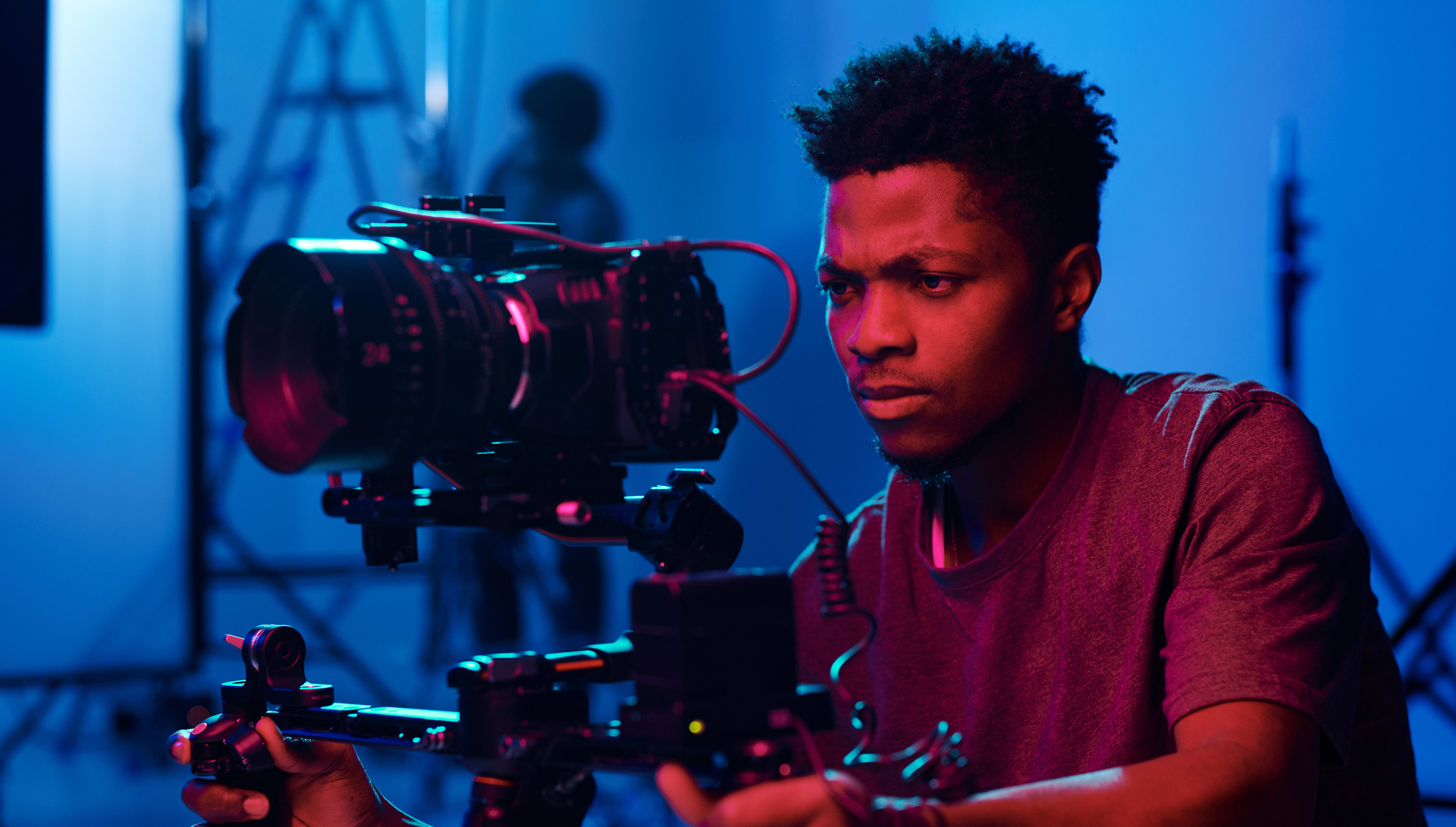 Man operating a camera with gimbal.