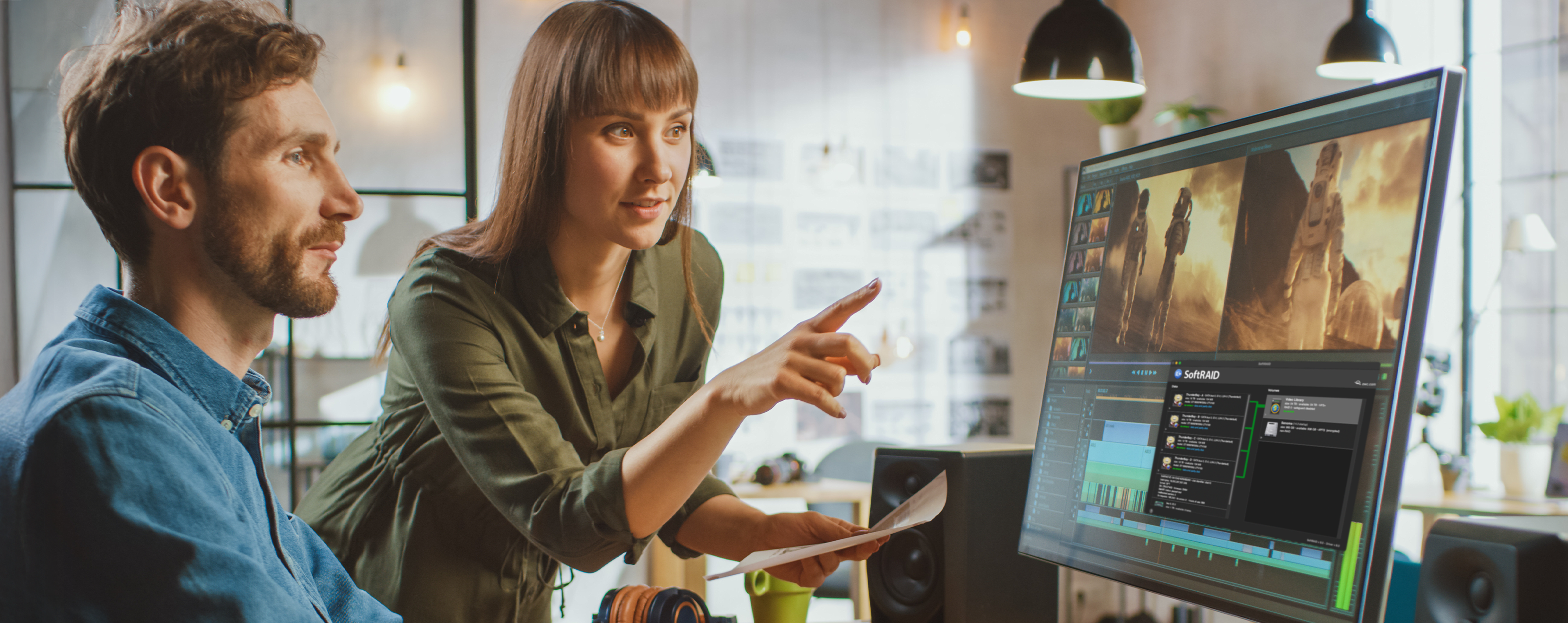 Man and woman working at a video editing workstation
