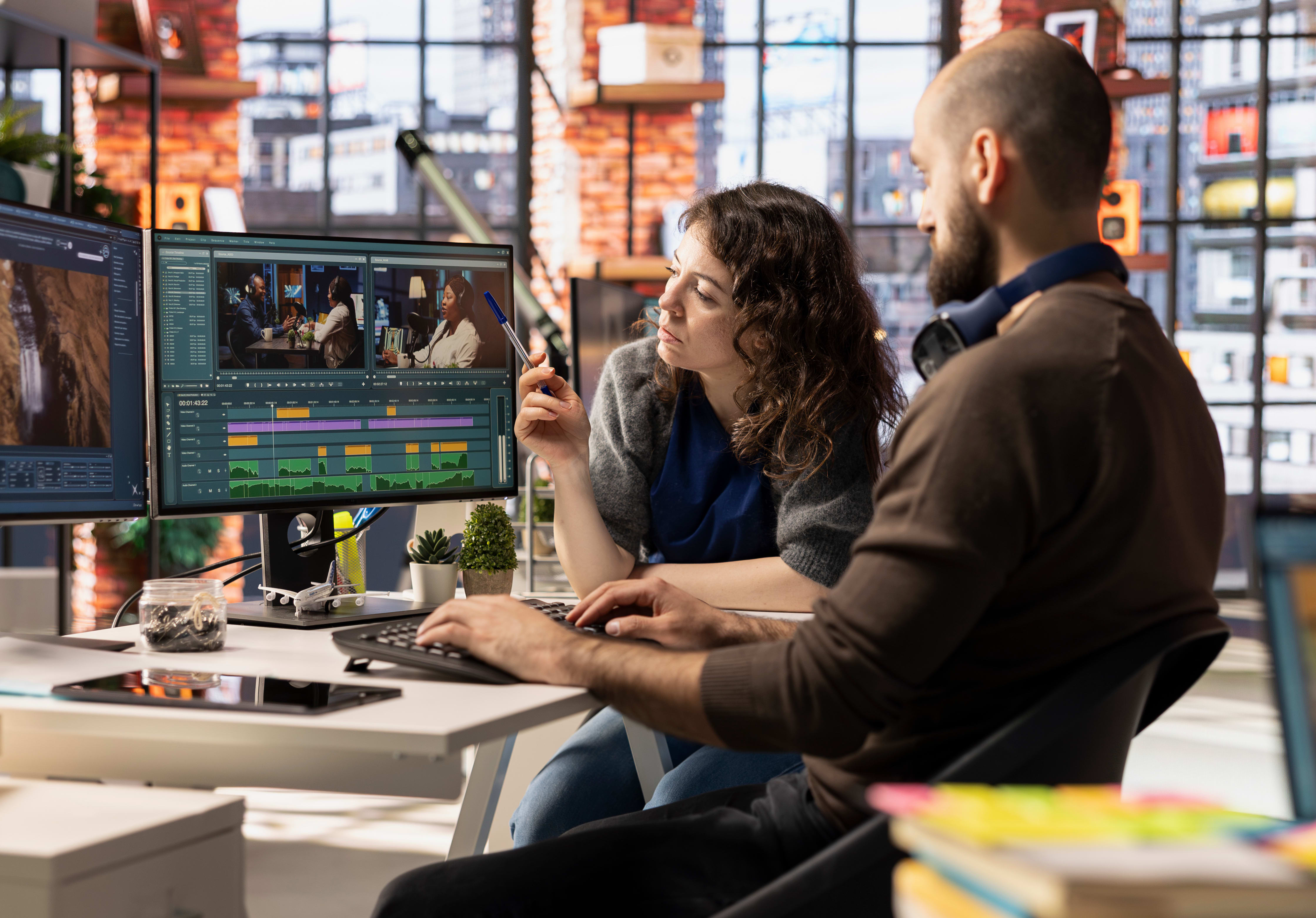 Two individuals collaborating on an editing project.