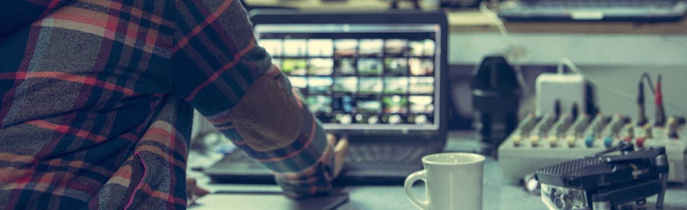 Video editor working at workstation