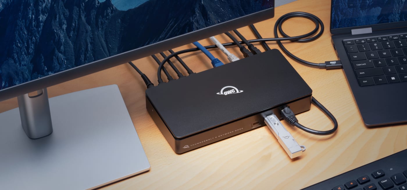 OWC Thunderbolt 5 Dual 10GbE Network Dock on desk with OWC Envoy Pro mini