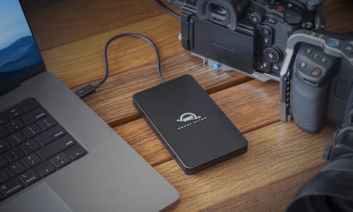 OWC Envoy Ultra on desktop with MacBook Pro and camera