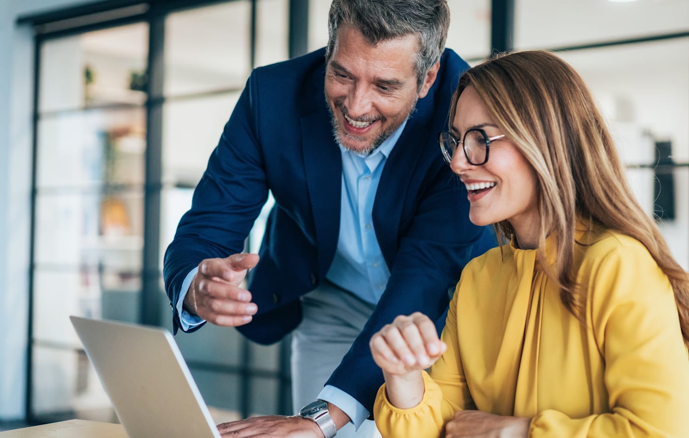 Man and woman looking at laptop screen