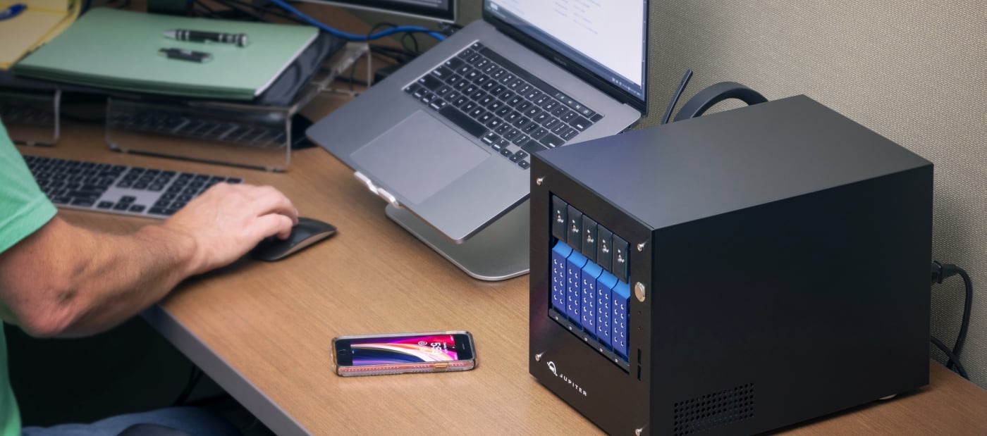 OWC Jupiter Mini on desktop with laptop and phone