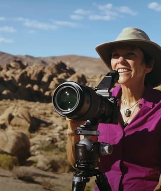 Photo of Karen Hutton, photographer, behind her camera