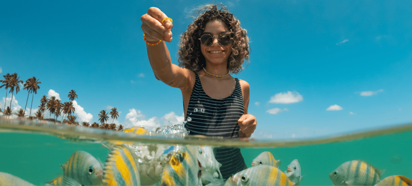 Girl feeding fish