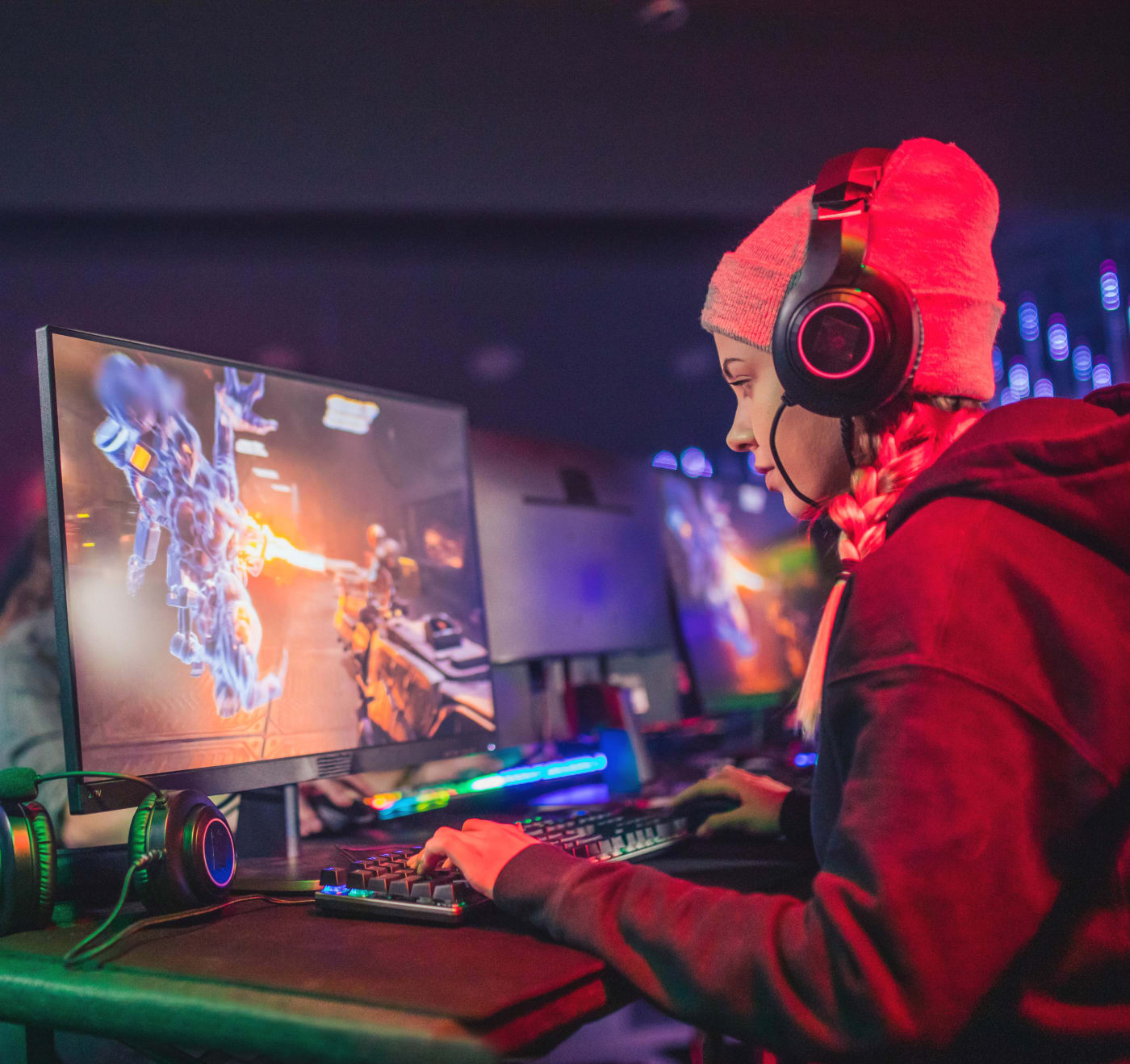Woman with headset gaming on a computer.