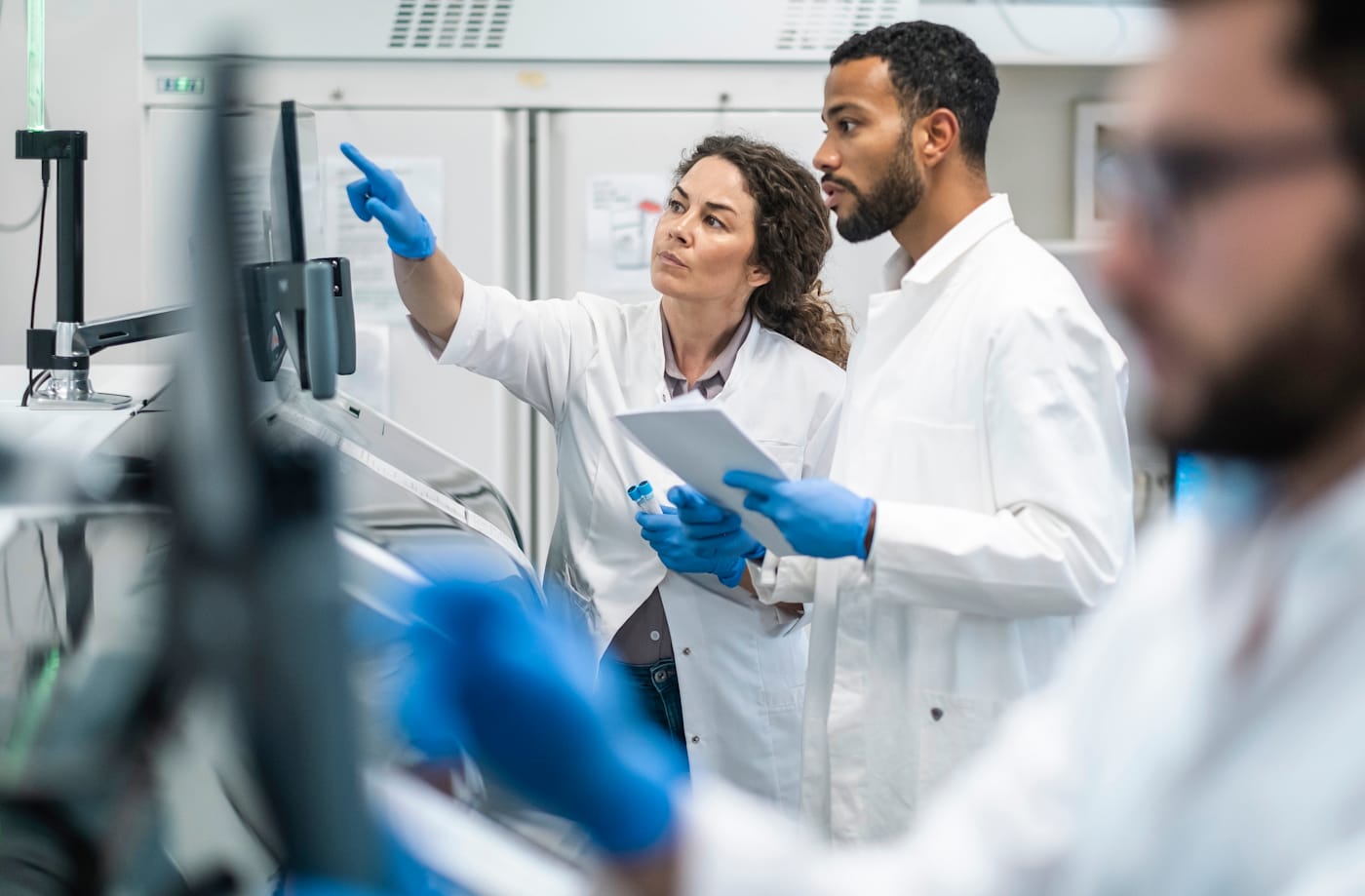 Two scientist reviewing information on a display