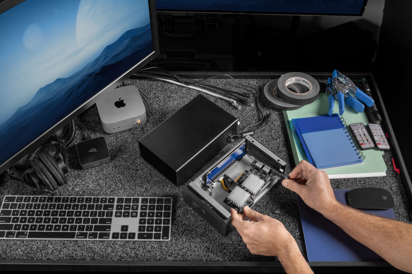 OWC Mercury Helios 5S top-down view with chassis open, installing a PCIe expansion card