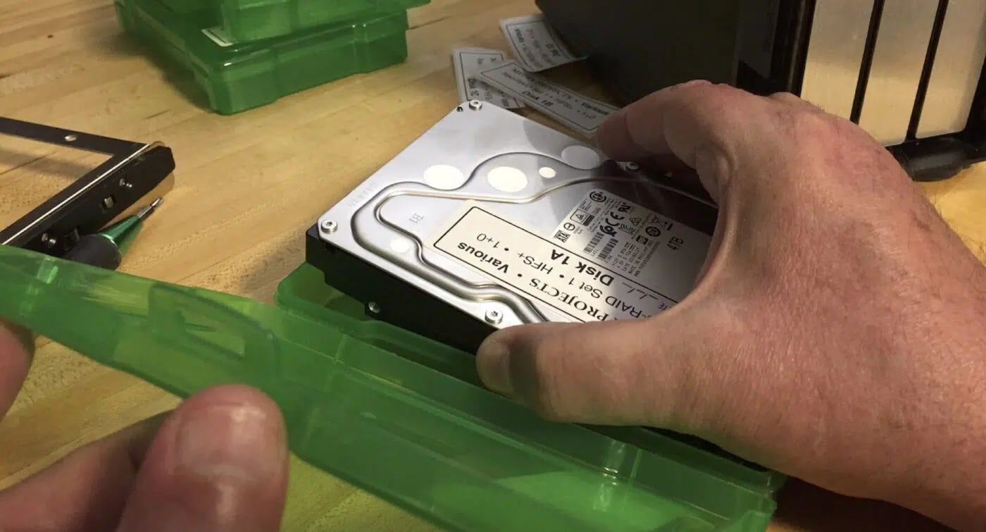 placing a labeled hard drive into storage case