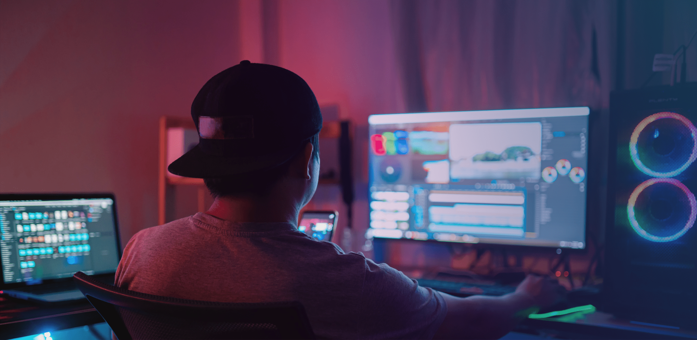 Over-the-shoulder shot of a video editor working at a workstation