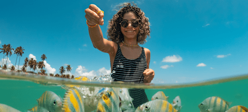 Girl feeding fish
