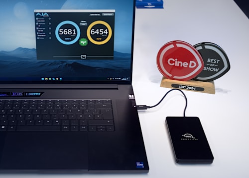 OWC Envoy Ultra plugged into laptop computer next to Cine D Best of Show Award 2024