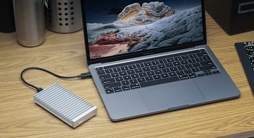 OWC Express 1M2 on deskto with MacBook Pro