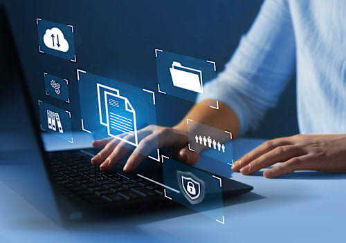 Closeup of a person's hands using a laptop with security imagery overlasy