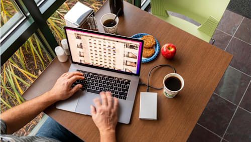 OWC Mercury Elite Pro mini with MacBook Pro at a cafe