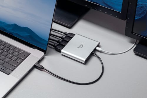 Closeup of an OWC USB-C Quad HDMI® 4K Display Adapter connected to a MacBook Pro