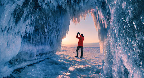 Photographer in ice cave