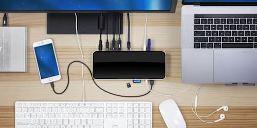 OWC 14-Port Thunderbolt Dock on desktop with display, iPhone, Mac, keyboard, mouse and storage