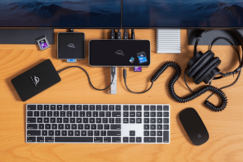 OWC Thunderbolt 5 Dock on desktop with OWC Envoy Ultra, OWC USB4 CFexpress 4.0 Type B Card Reader, OWC Envoy Pro mini, OWC Express 1M2, headphones, mouse, keyboard, and more