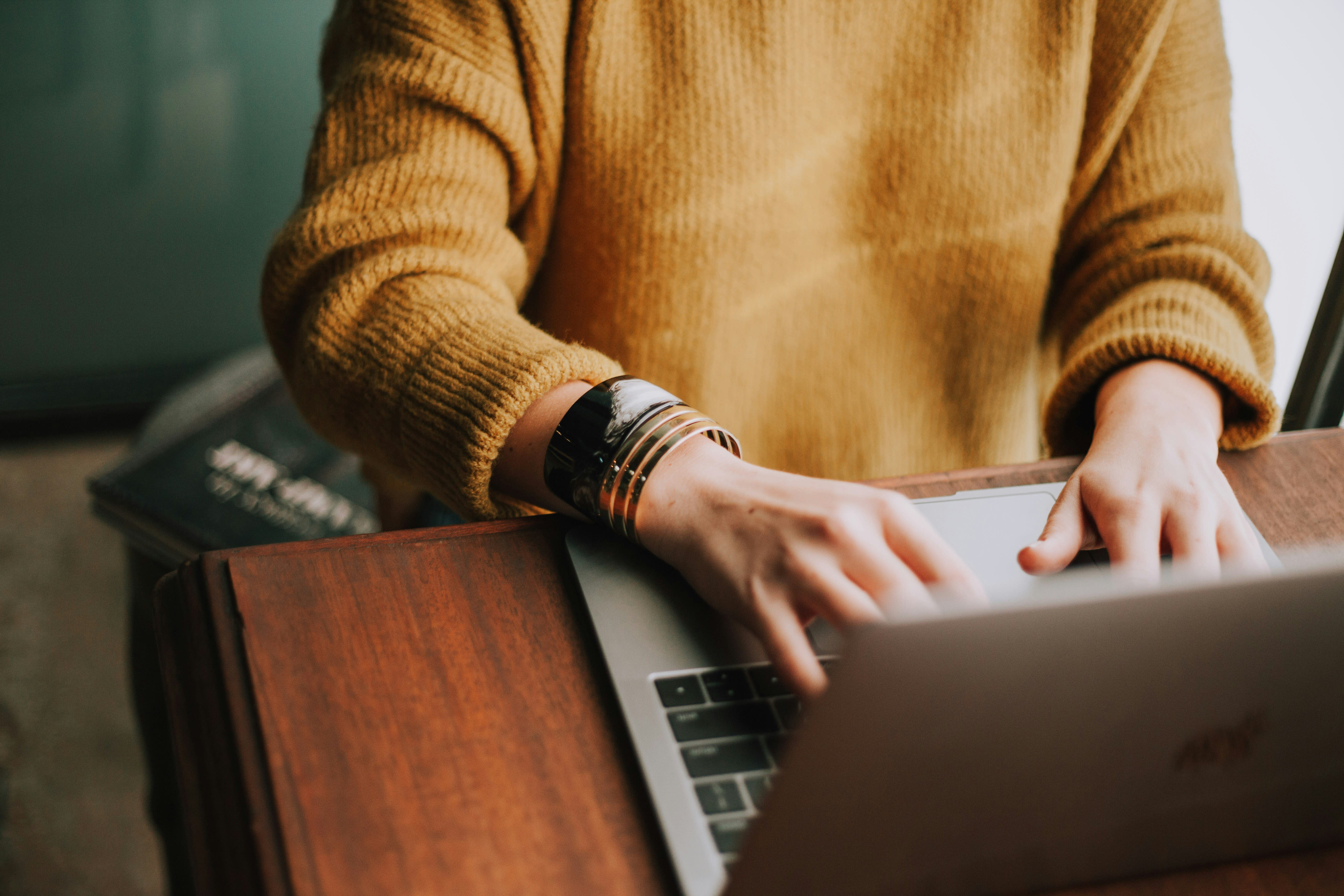 Closeup of woman working on laptop