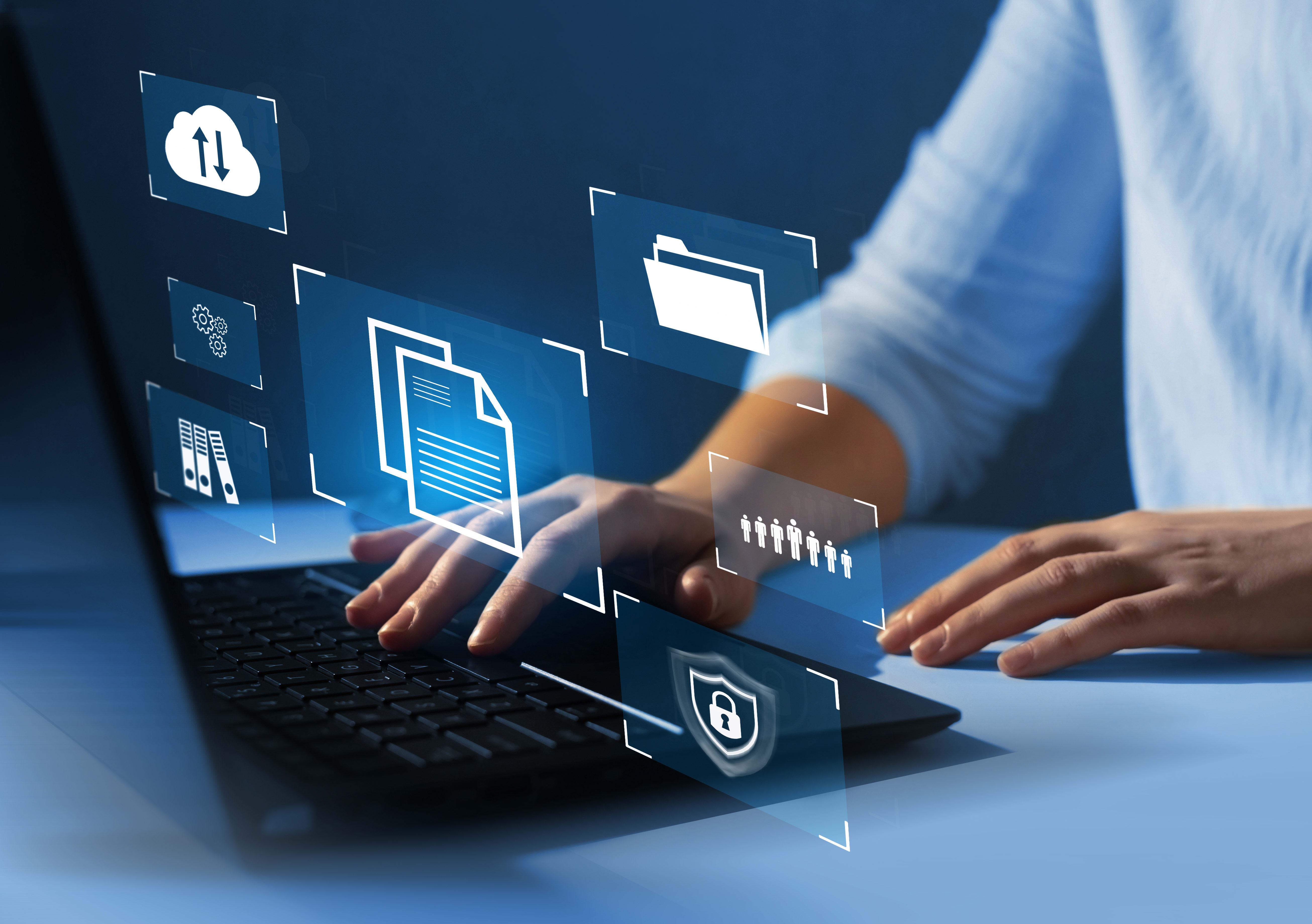 Closeup of a person's hands using a laptop with security imagery overlasy
