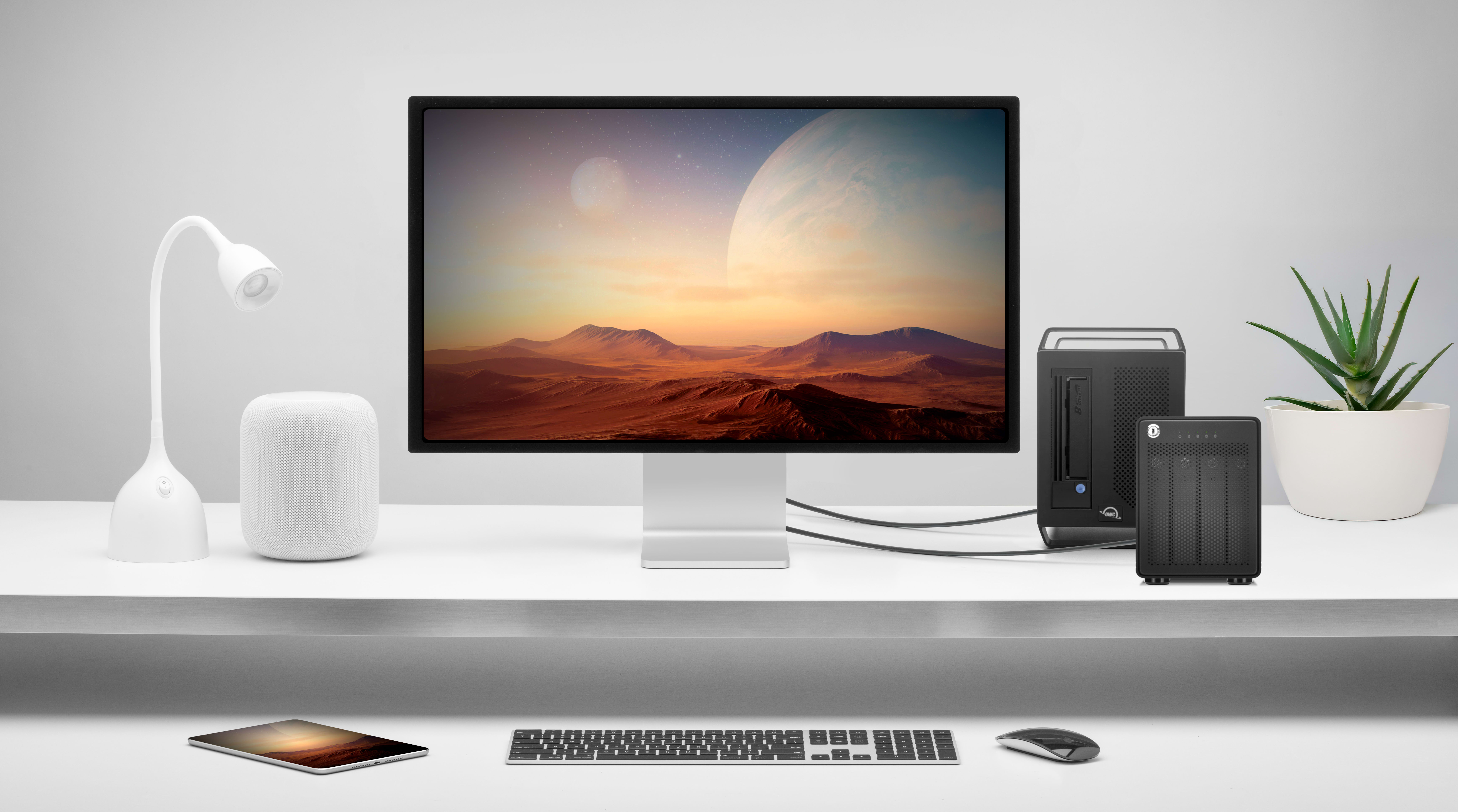 White desktop with a display and OWC Archive Pro next to a keyboard and mouse